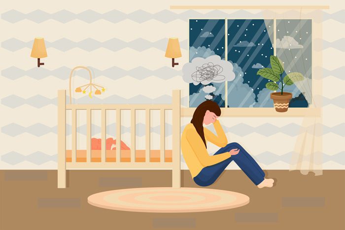 illustration of new mom sitting beside baby's crib depressed - Postpartum Depression